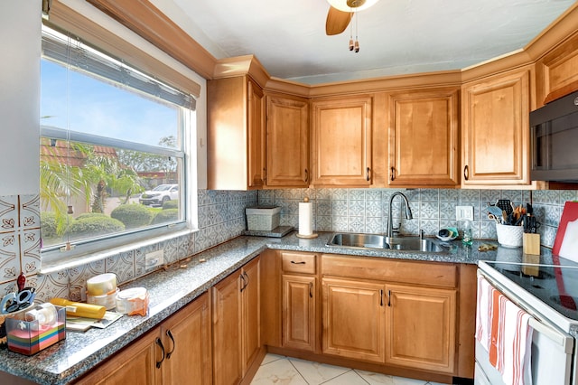 kitchen featuring electric stove, tasteful backsplash, ceiling fan, and sink