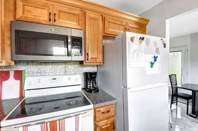 kitchen with tasteful backsplash, white appliances, and light tile floors