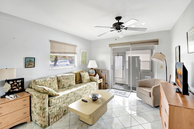 tiled living room featuring ceiling fan