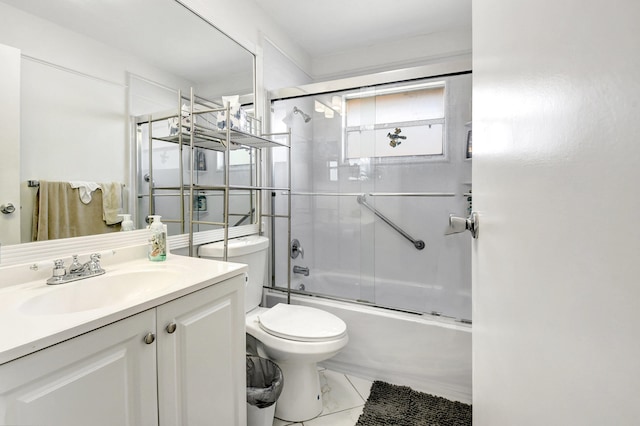 full bathroom featuring enclosed tub / shower combo, toilet, tile floors, and vanity with extensive cabinet space