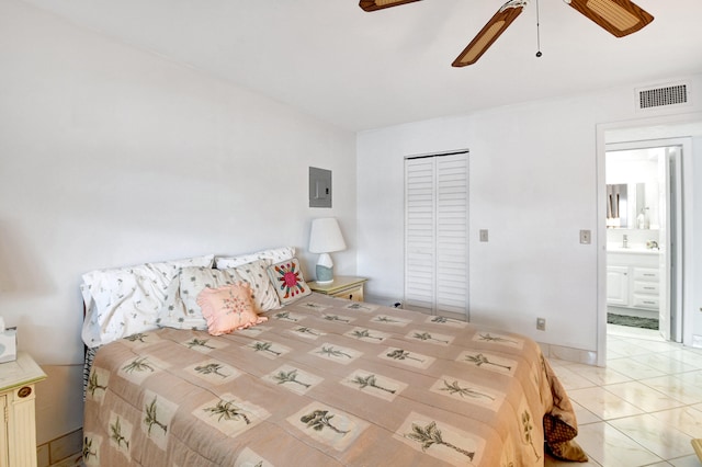 bedroom with ensuite bathroom, a closet, ceiling fan, and light tile floors