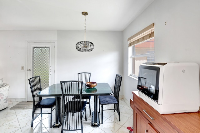 dining room featuring a chandelier and light tile flooring