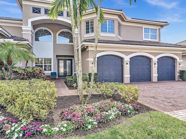 view of front of home with a garage and french doors