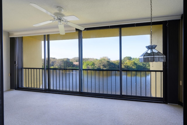 unfurnished sunroom with a water view, a healthy amount of sunlight, and ceiling fan