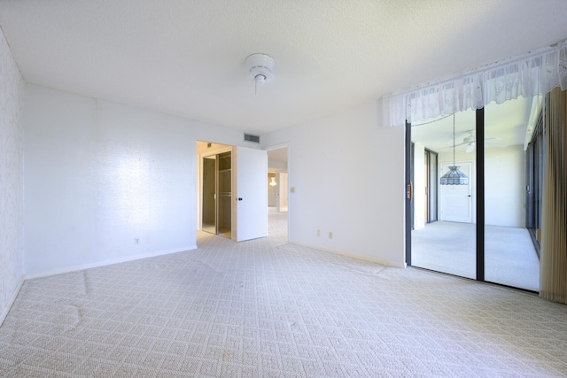 empty room featuring light carpet