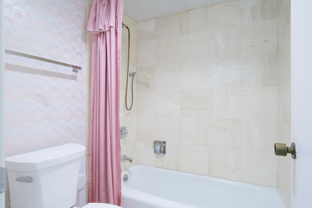 bathroom featuring toilet and shower / tub combo with curtain