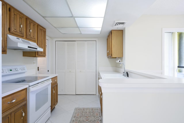 kitchen featuring light tile floors and white electric stove