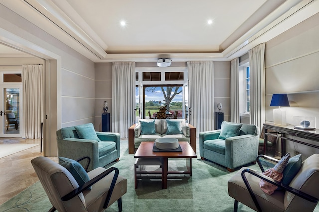 tiled living room featuring a tray ceiling