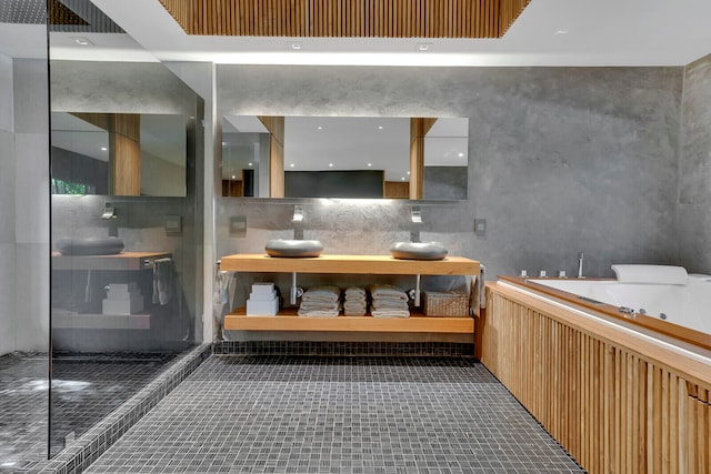 bathroom featuring tasteful backsplash, tile floors, vanity, and a tub