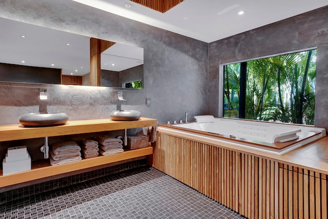 bathroom with a bathing tub, tasteful backsplash, vanity, and tile flooring