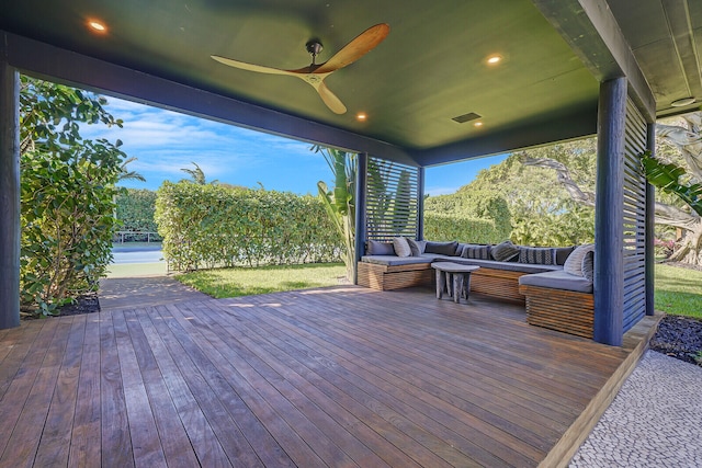 wooden terrace with an outdoor hangout area and ceiling fan