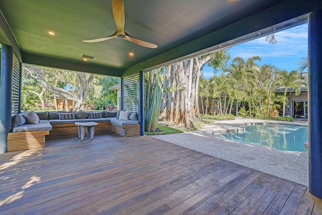 wooden terrace with an outdoor hangout area and ceiling fan