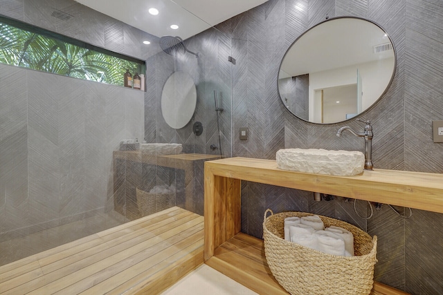 bathroom featuring sink and tile walls