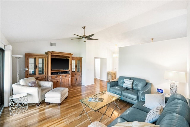 living room featuring light hardwood / wood-style flooring, ceiling fan, and high vaulted ceiling