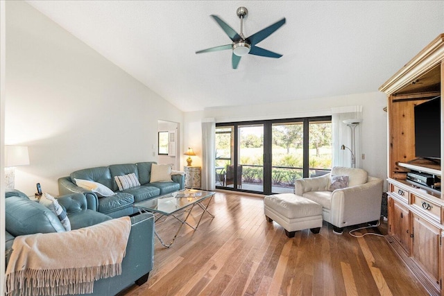 living room with lofted ceiling, ceiling fan, and hardwood / wood-style floors