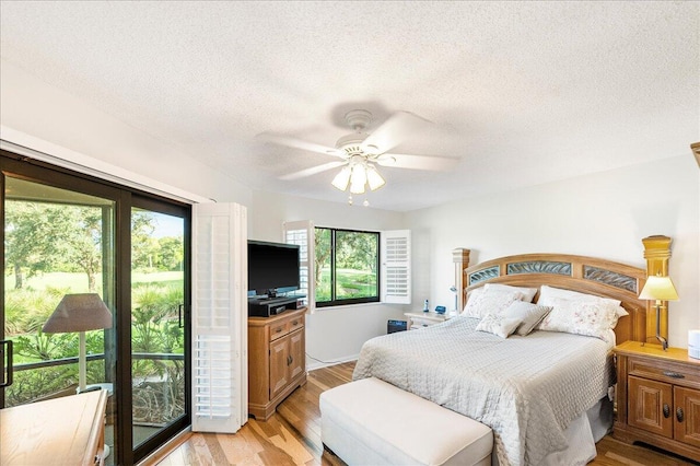 bedroom with ceiling fan, a textured ceiling, and light hardwood / wood-style flooring