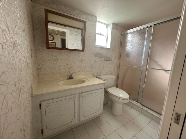 bathroom featuring vanity, tile floors, toilet, and walk in shower