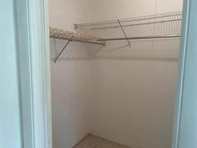 spacious closet featuring tile floors