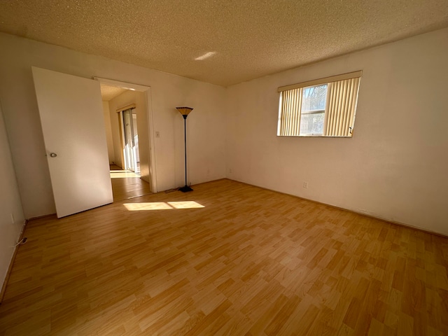 unfurnished bedroom featuring light hardwood / wood-style floors and a textured ceiling