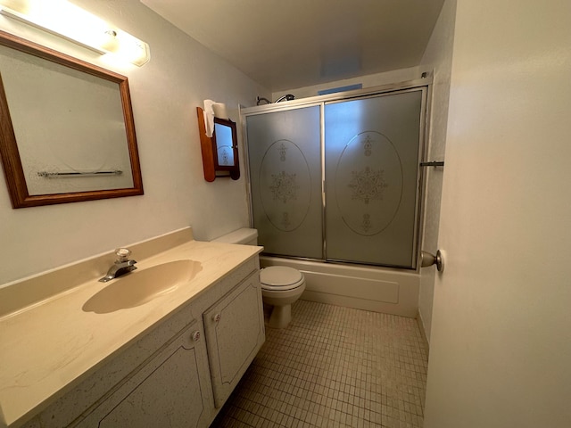 full bathroom with shower / bath combination with glass door, toilet, large vanity, and tile floors