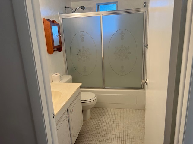 full bathroom featuring vanity, tile floors, bath / shower combo with glass door, and toilet