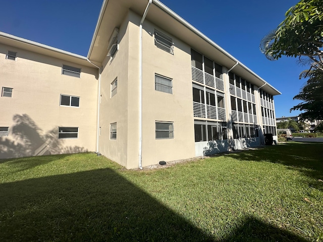 view of property exterior featuring a lawn