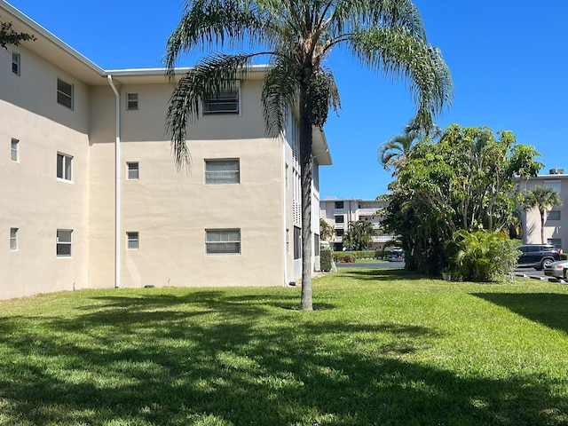 back of property featuring a lawn