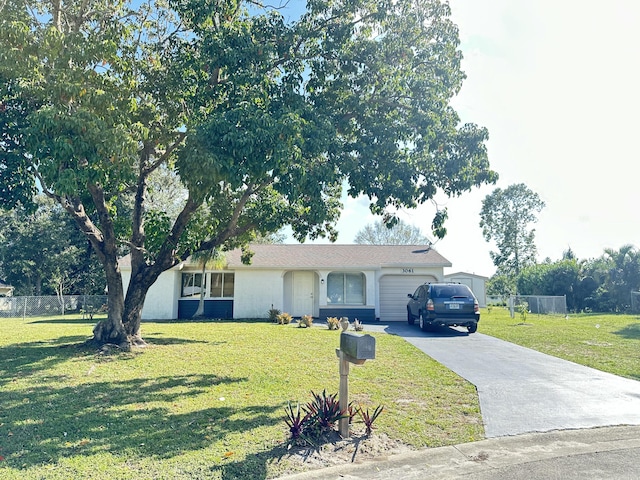 single story home featuring a garage and a front lawn