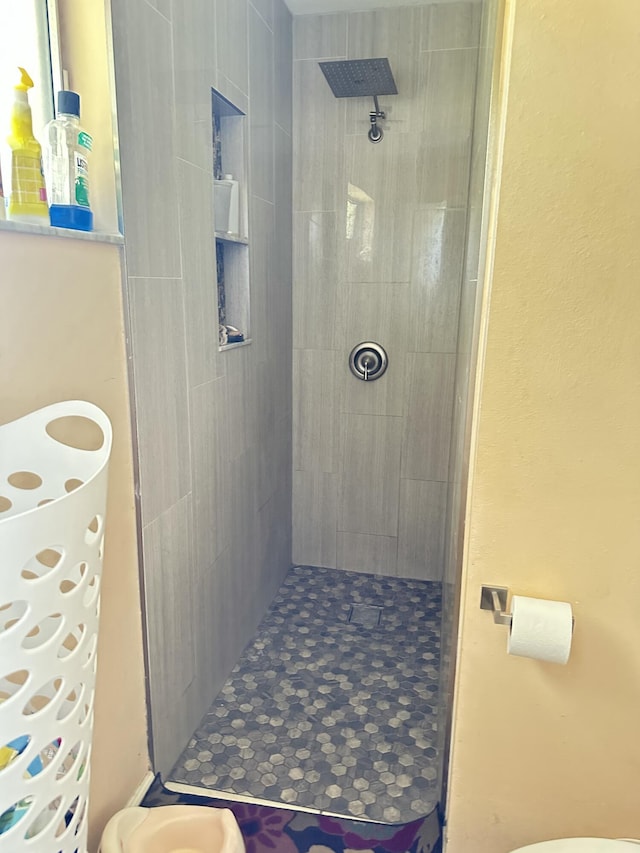 bathroom with a tile shower