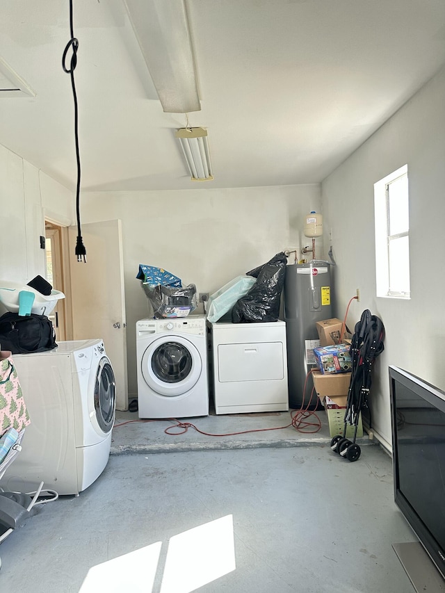 clothes washing area featuring washer and dryer and electric water heater