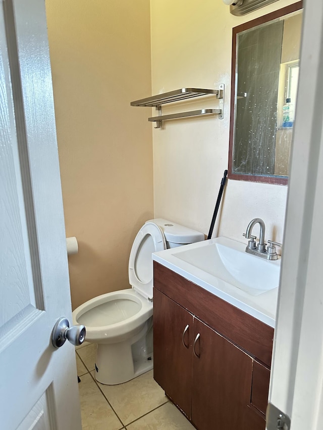 bathroom featuring tile patterned floors, vanity, and toilet