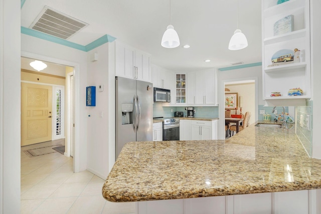 kitchen with kitchen peninsula, stainless steel appliances, sink, pendant lighting, and white cabinetry