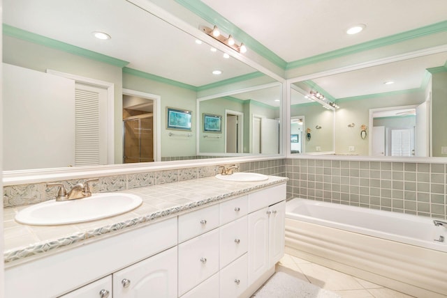 bathroom with tile patterned flooring, vanity, and a washtub