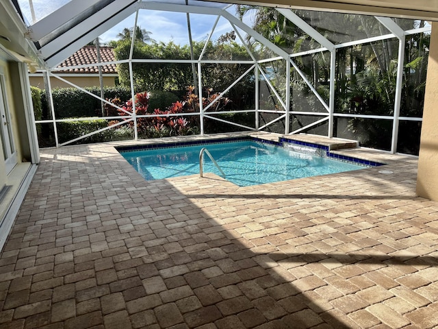 view of swimming pool with a lanai and a patio area