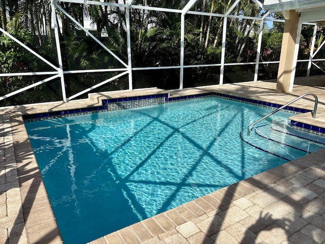 view of pool with a lanai and a patio area