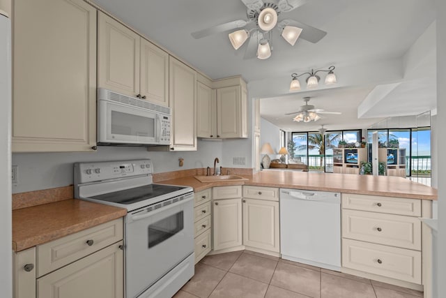 kitchen with white appliances, ceiling fan, sink, light tile flooring, and cream cabinets