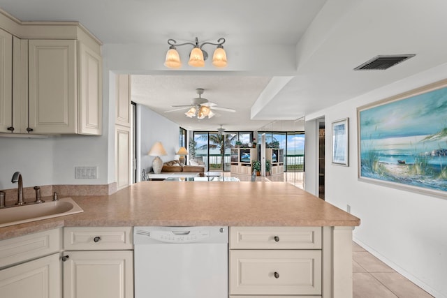 kitchen featuring kitchen peninsula, sink, ceiling fan, light tile floors, and dishwasher