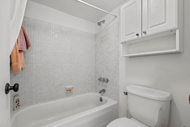 bathroom featuring toilet and tiled shower / bath combo