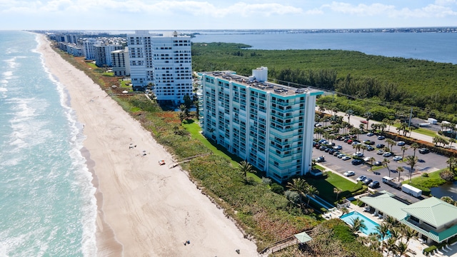 drone / aerial view featuring a view of the beach and a water view