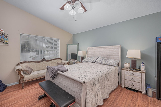 bedroom featuring hardwood / wood-style flooring, ceiling fan, and lofted ceiling