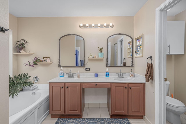 bathroom featuring tile patterned flooring, vanity, a bath, and toilet