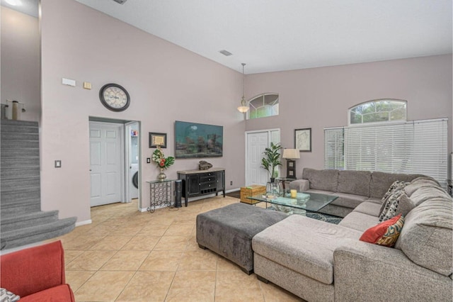 tiled living room with a high ceiling