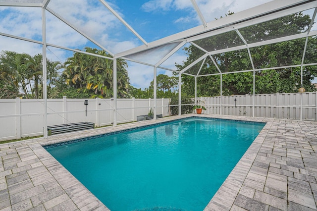 view of pool with a patio and a lanai