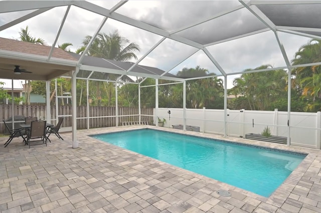 view of pool featuring a lanai, a patio area, and ceiling fan