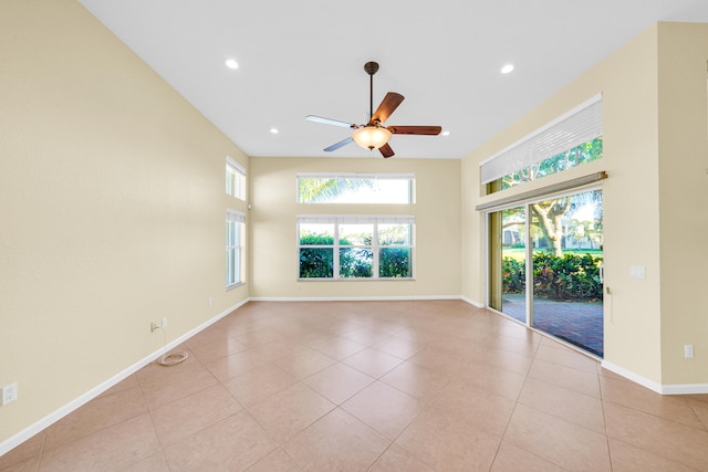 tiled spare room featuring ceiling fan