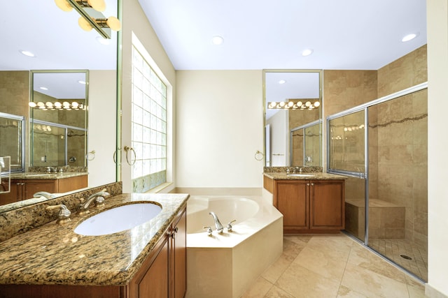 bathroom with independent shower and bath, double vanity, and tile floors