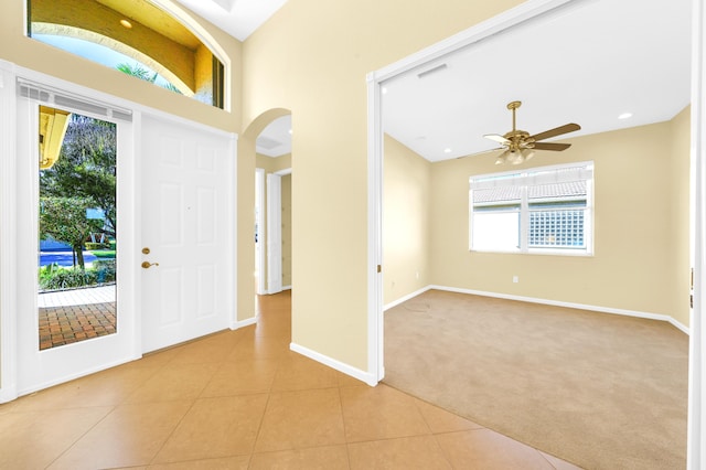 entrance foyer featuring light tile floors, plenty of natural light, and ceiling fan