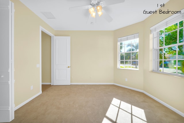 carpeted empty room with ceiling fan