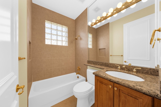 full bathroom featuring tiled shower / bath, toilet, tile flooring, and vanity