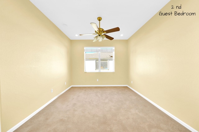 unfurnished room featuring light carpet and ceiling fan